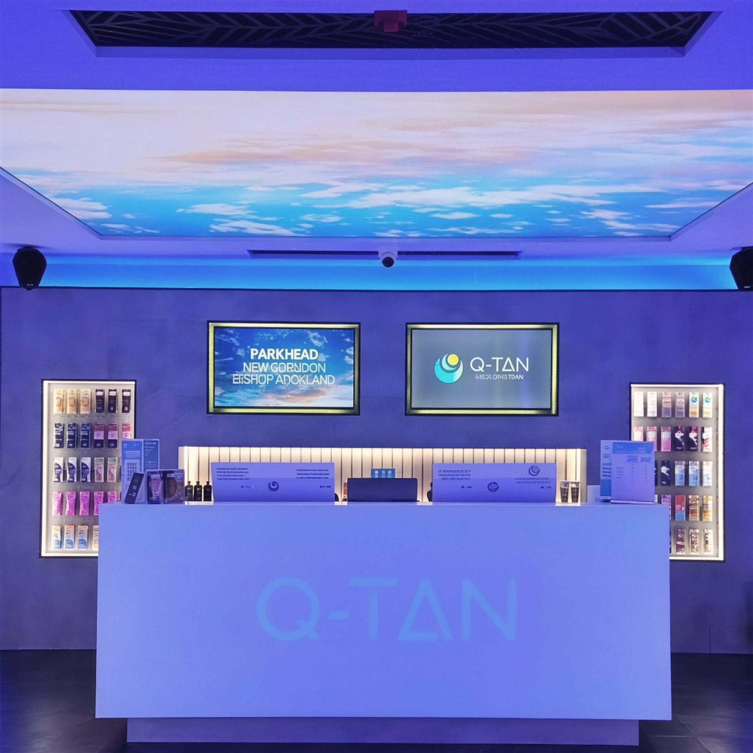 Symmetrical finished tanning salon reception with backlit sky ceiling panel, illuminated product niches and a glowing branded counter.