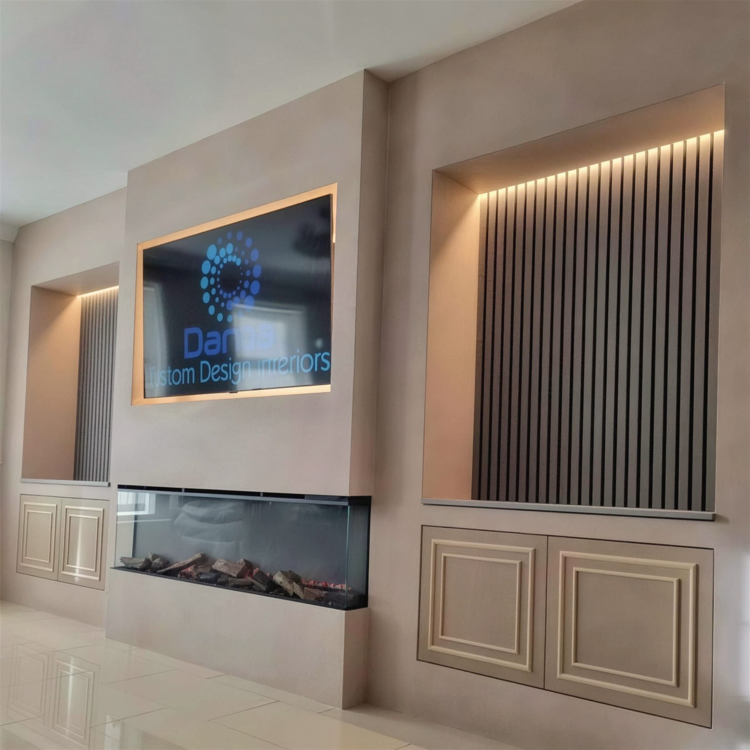 Symmetrical cream plaster media wall with warm LED slat niches, linear fireplace and panelled cabinetry, Daros logo on screen.